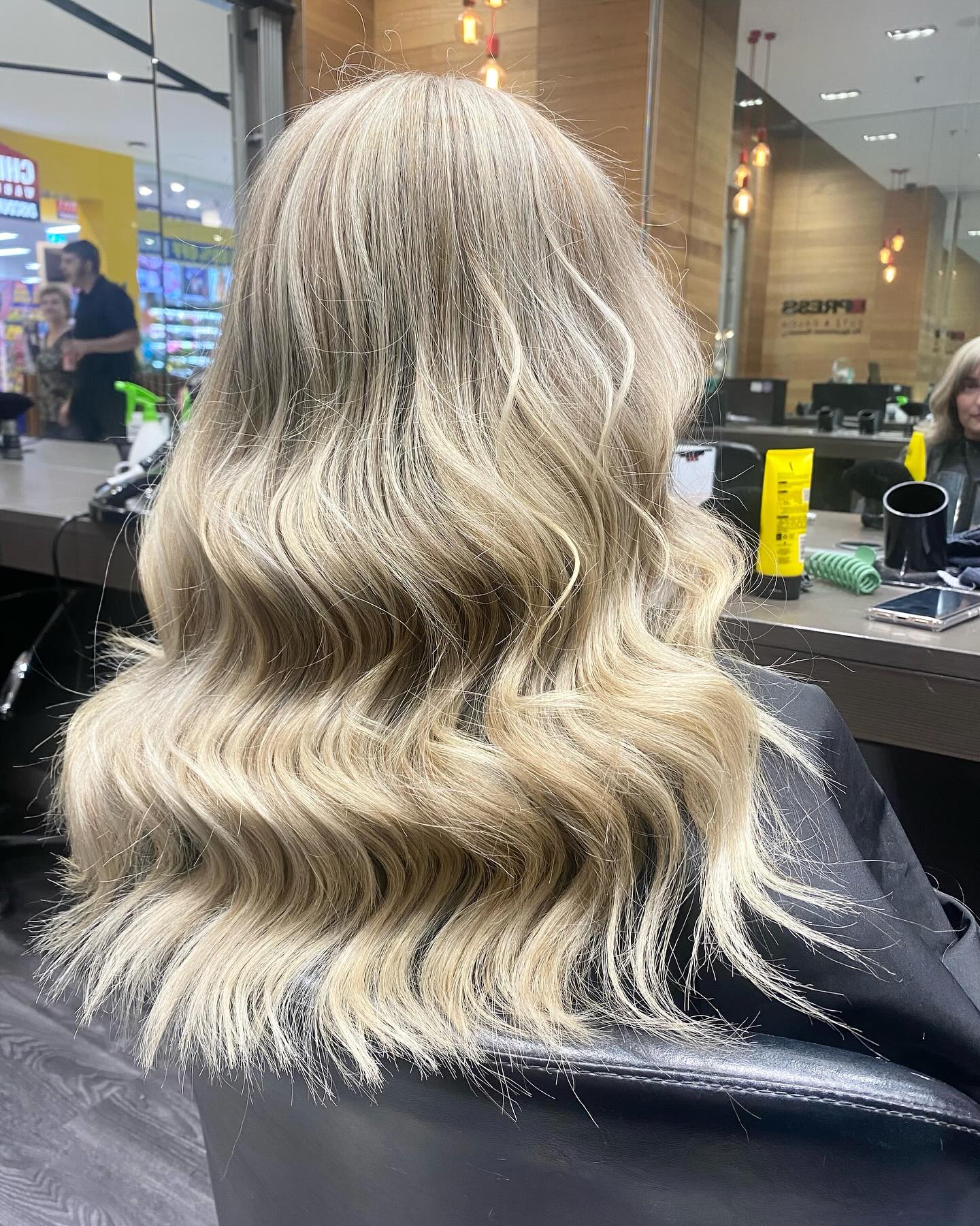 Long blonde waves styled to finish