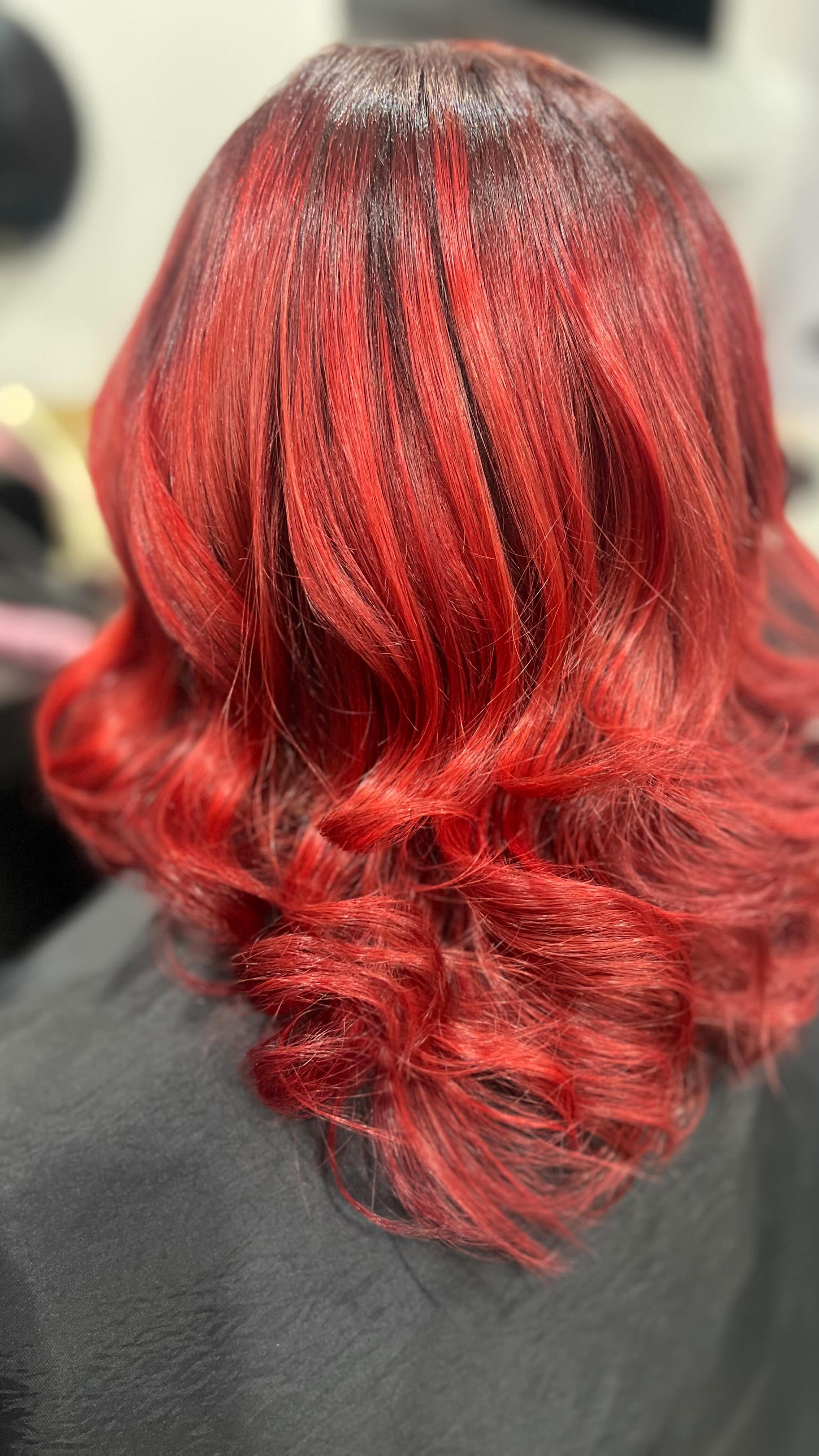 Vivid red all-over colour with a curled blow wave